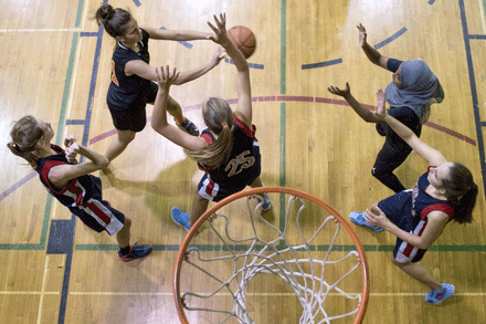 Female Athletes attack the net during the basketballgame