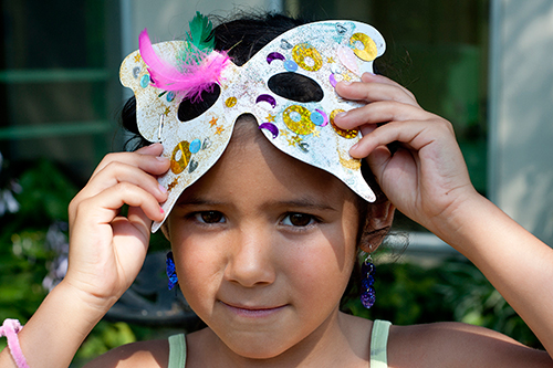 Young girl with a butterfly eye mask