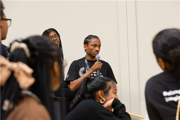 Image of student speaking through microphone
