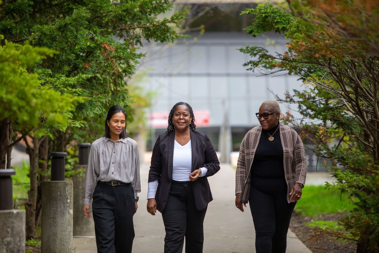 Photo of Paula walking with her two colleagues.