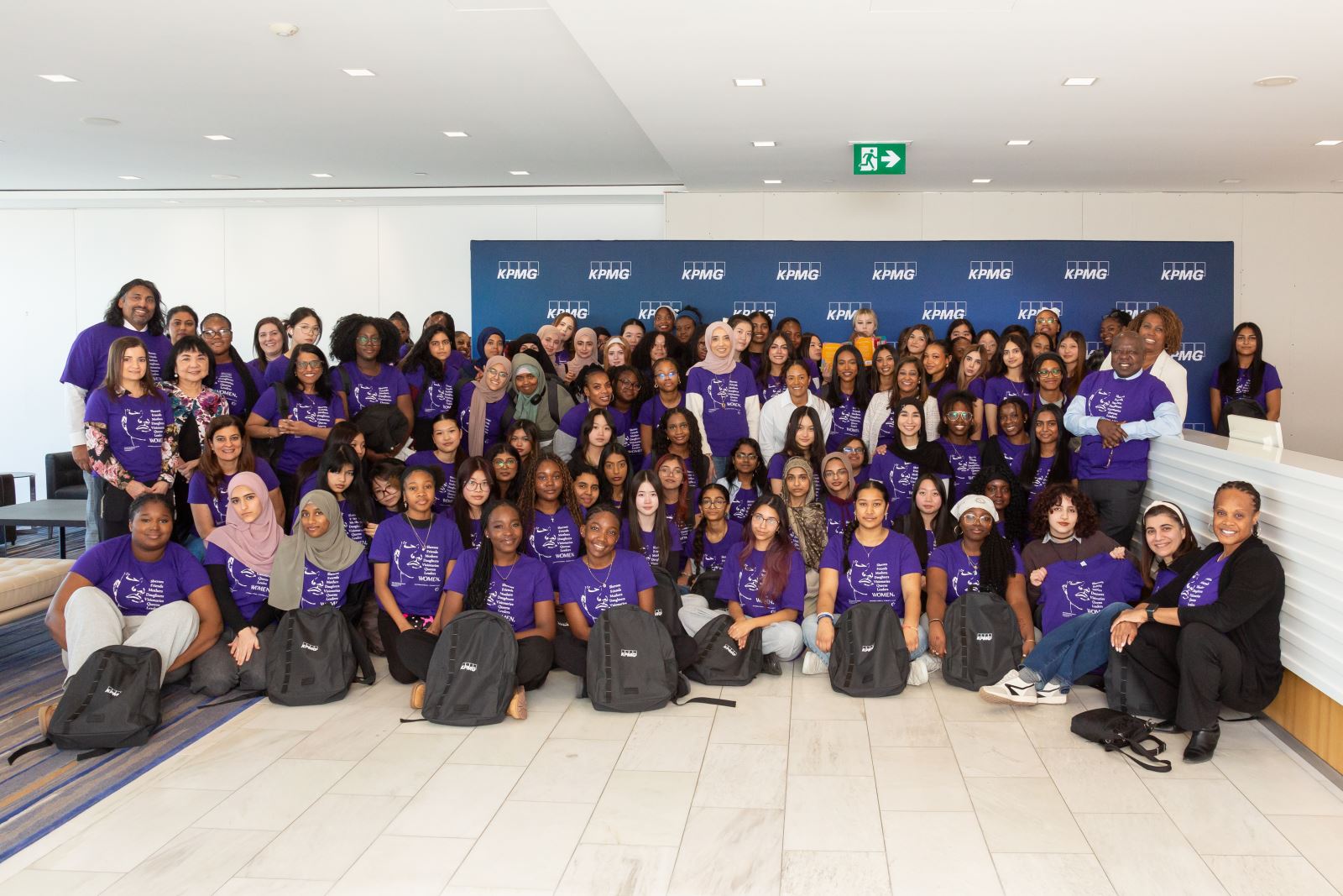 group photo of all KPMG International Women’s Day event attendees and organizers wearing purple shirts