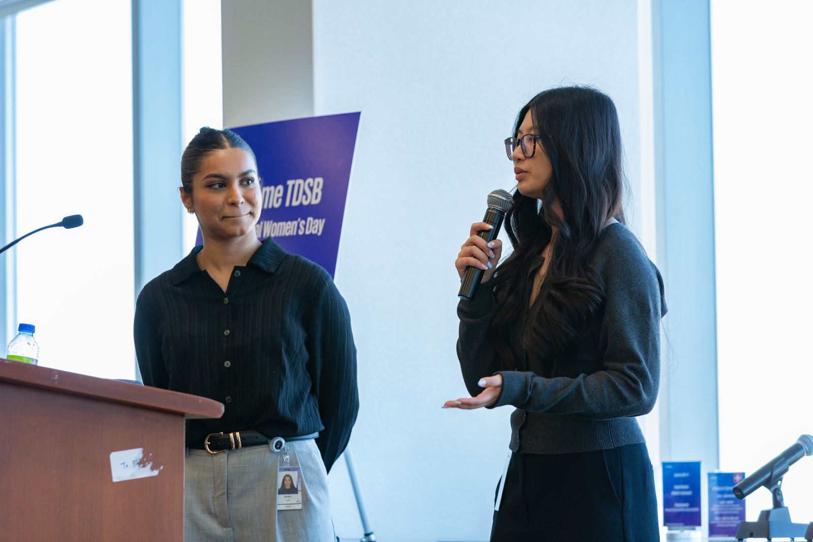 two speakers at podium