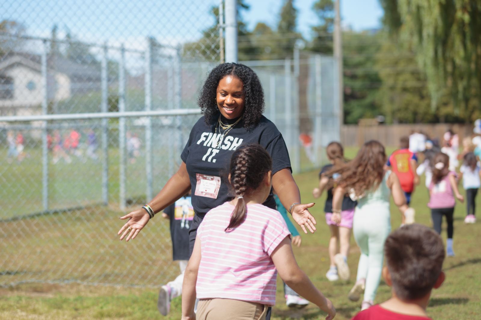 Photo of Tynesha giving a high five to students