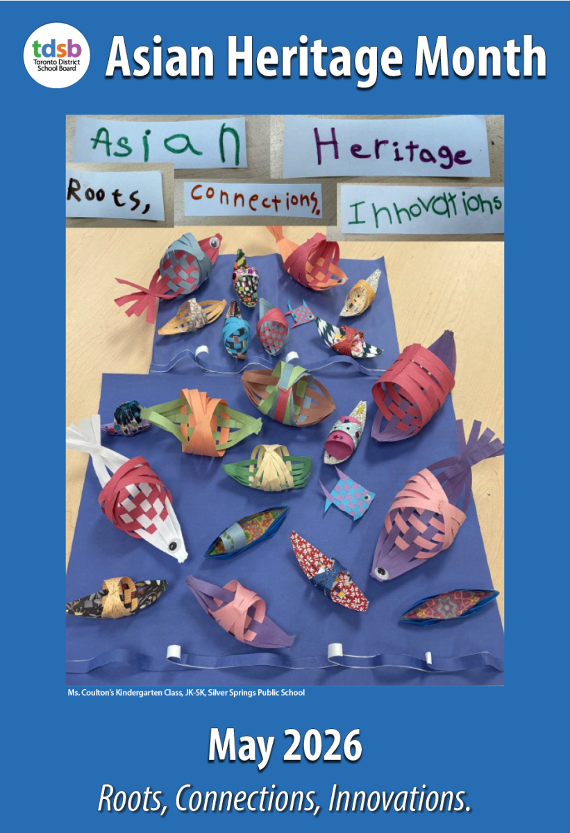 Photograph of a classroom art display for Asian Heritage Month featuring handmade paper crafts arranged on a blue background. The display includes woven paper fish and lantern shapes in various colours and patterns. Above the artwork are paper labels reading “Asian Heritage,” “Roots,” “Connections,” and “Innovations.” The poster also includes the text “May 2026” and the theme “Roots, Connections, Innovations.”