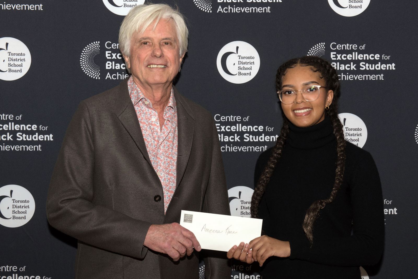  Ameena Kane receives an cheque.