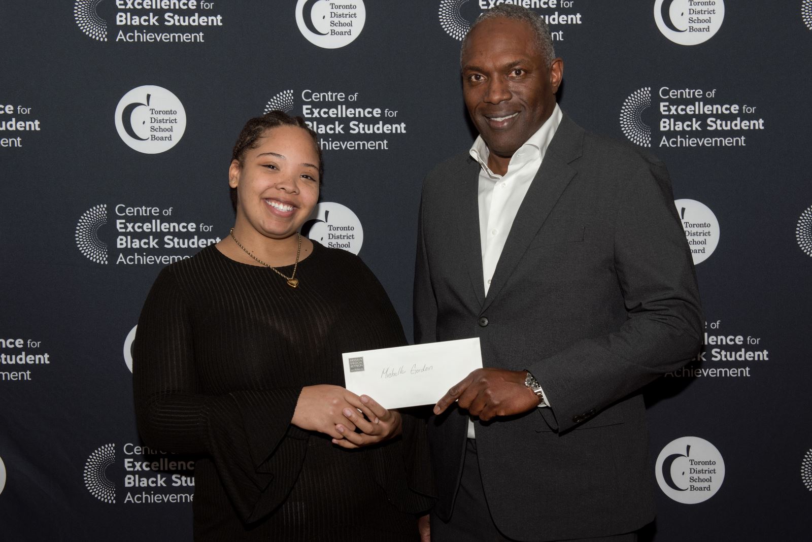 Michelle Gordon receives a cheque.