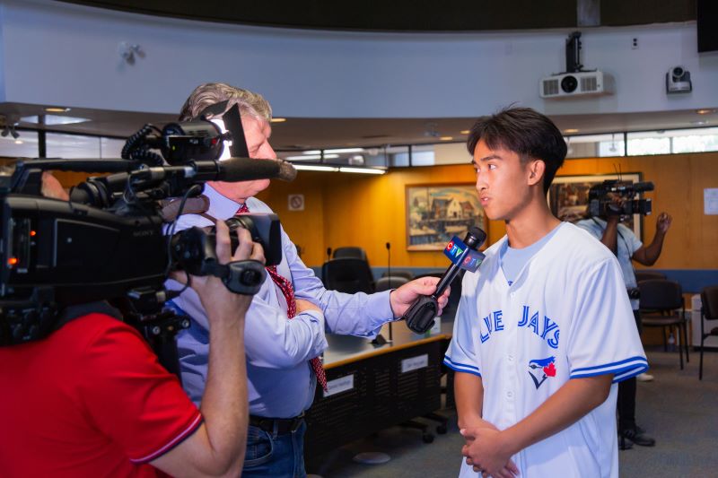 TDSB Top Scholar Charlie Li being interviewed by the media about his accomplishment.