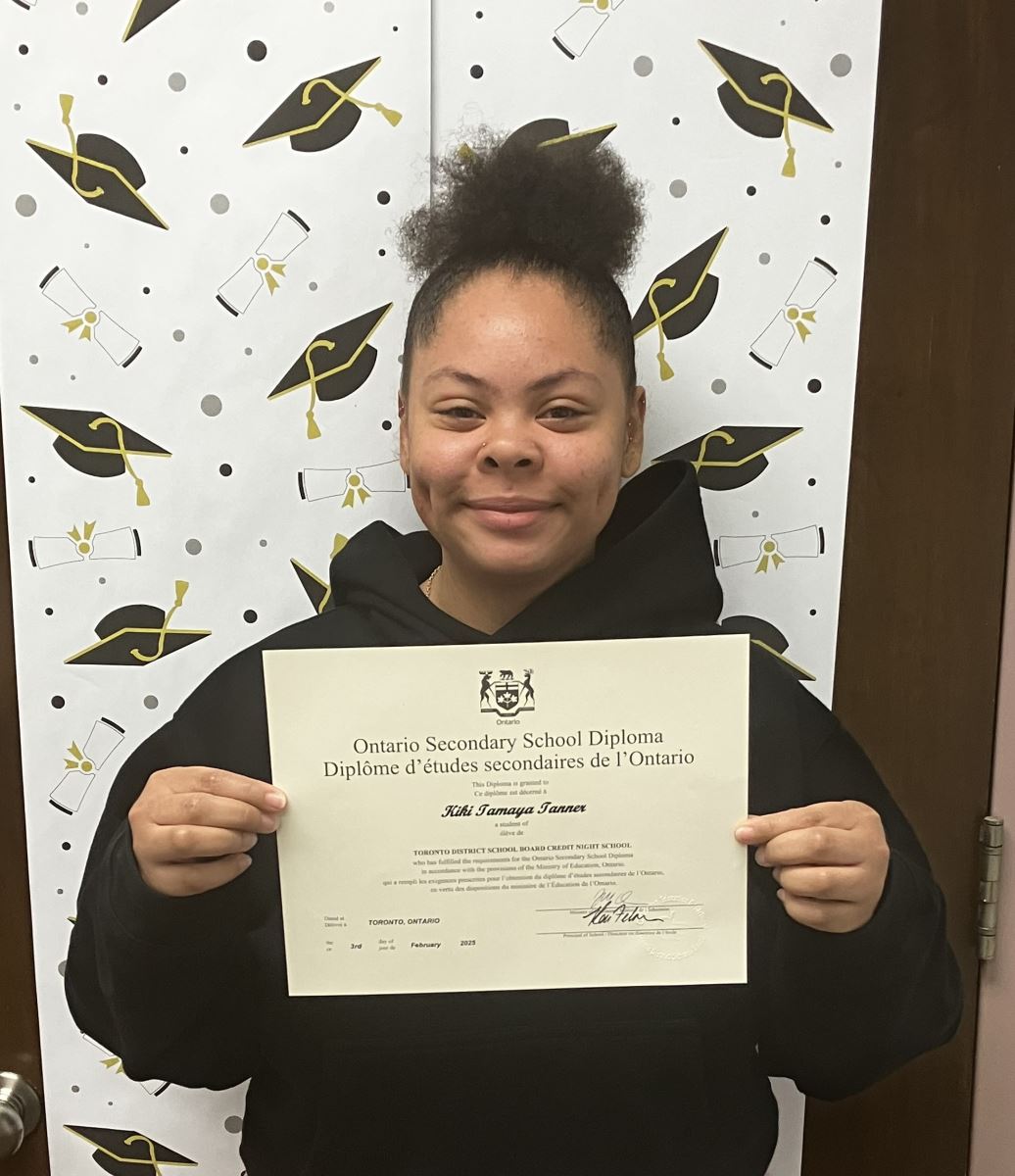 A school classroom door decorated with cut outs of baseballs and children's posters reading "Go Blue Jays"