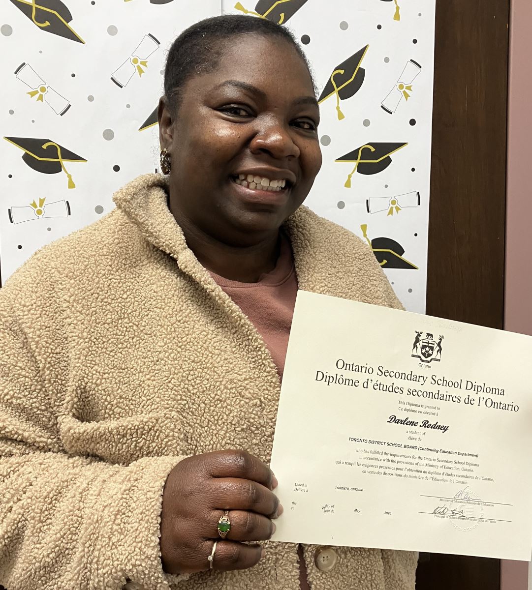 A school classroom door decorated with children's artwork and Blue Jays and logos and signs reading "Go Jays"