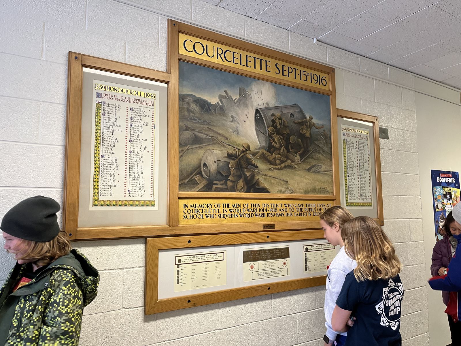 A school classroom door decorated with cut outs of baseballs and children's posters reading "Go Blue Jays"