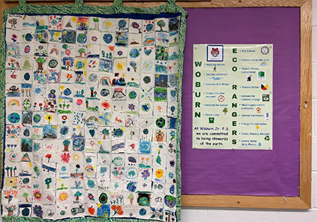 Display of large Eco Quilt hanging in school hallway