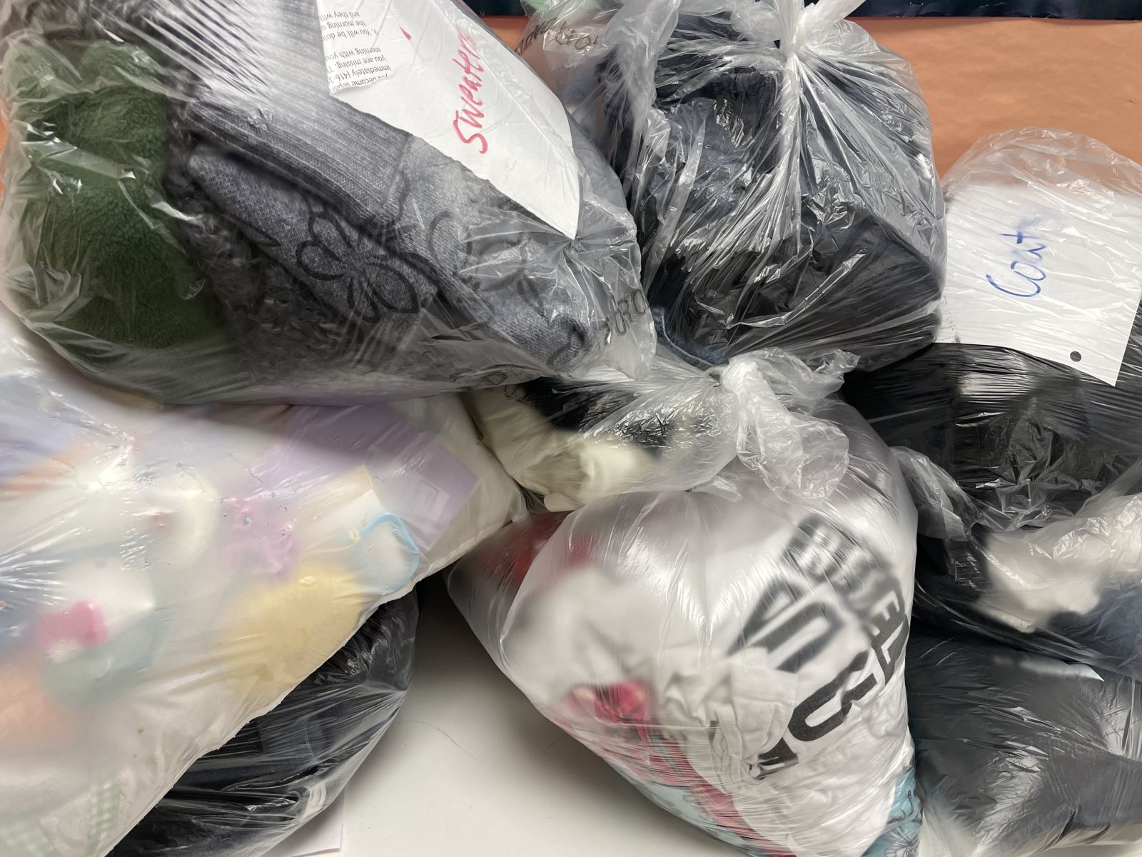 Clear plastic bags containing some of the clothing and textiles donated to Dr. Norman Bethune CI’s Environmental Action Team’s 2023 Clothing and Textiles Drive.