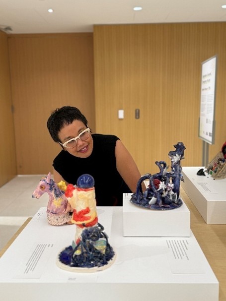 New York-based artist Linda Sormin looking at student artwork m inspired by her art concept displayed on raised platforms at Gardiner Museum in Toronto