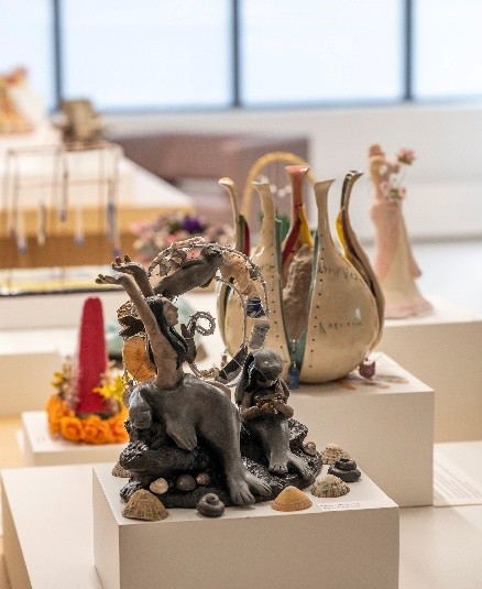 close up of student artwork displayed on raised platforms at Gardiner Museum in Toronto