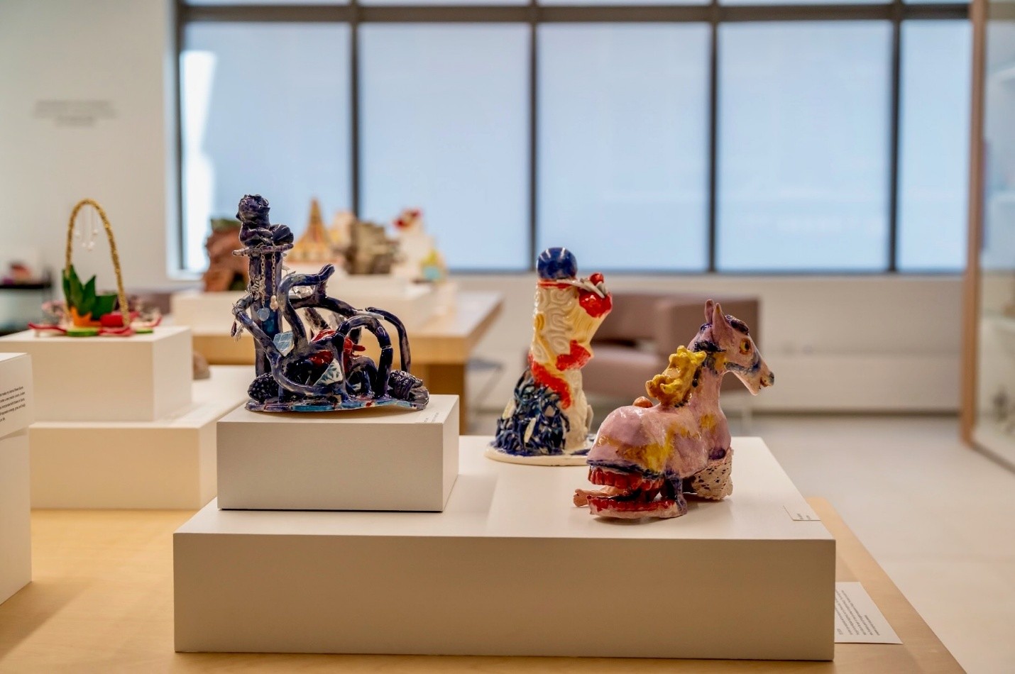 image of three pieces of student artwork displayed on raised platforms at Gardiner Museum in Toronto