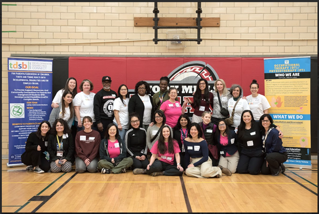 A group picture of TDSB staff who volunteered to host tdsb's planning for adulthood for students with disabilities transition fair posing for a photo