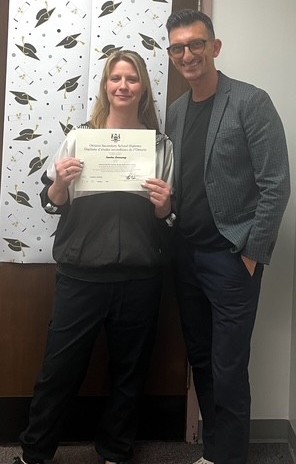 A school classroom door decorated with blue hearts, Blue Jays logos and "Let's Play Ball"