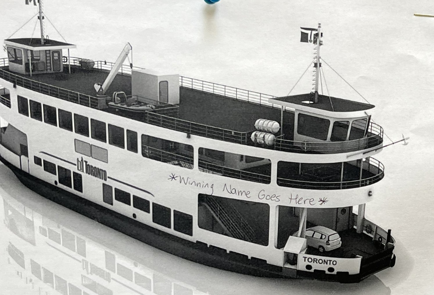 Image of a Toronto ferry with "Winning Name Goes Here" written on the front of the boat