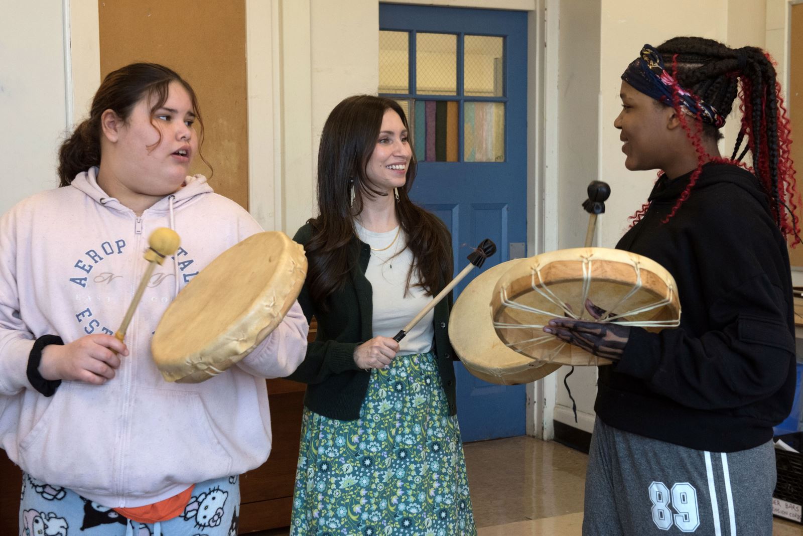 Photo of Tasha Smith with two students.