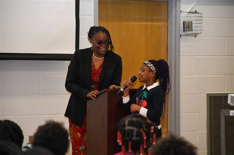 Student from Africentric Alternative School introduces speaker at African Heritage Month presentation.