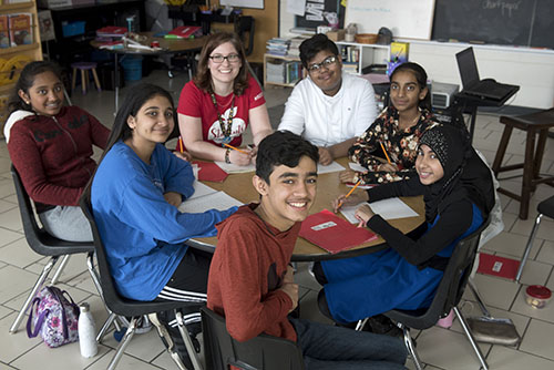 Members of the We Stand Equity Club sit around a table