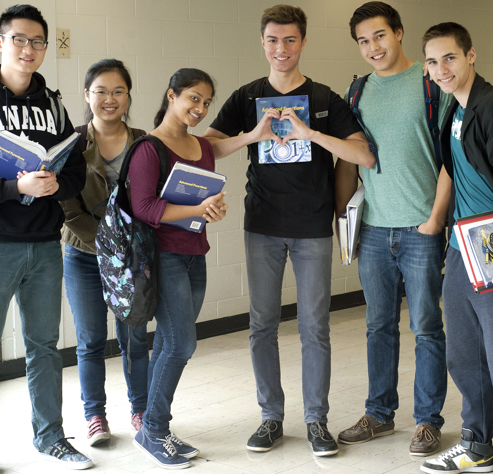 people walking across a hallway