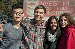 four students smiling for photo
