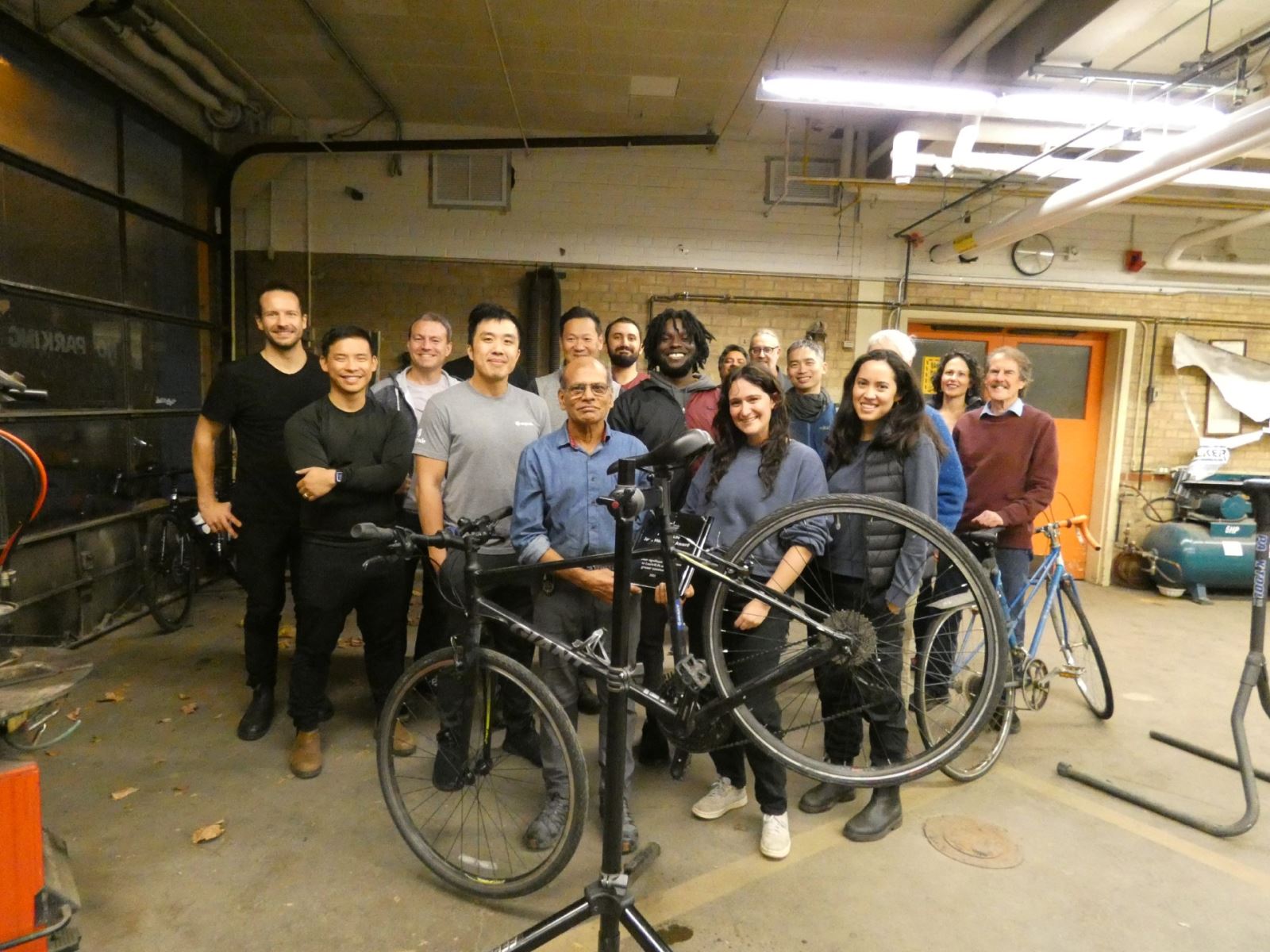 2023 Jack Henshaw Award Winner Narayana Reddy surrounded by a group of his bicycle repair course learners