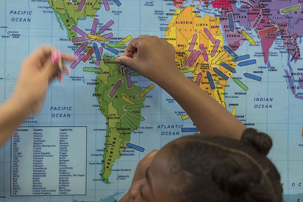 students place arrows on a map to a variety of countries