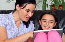 Parent with child looking at a computer tablet
