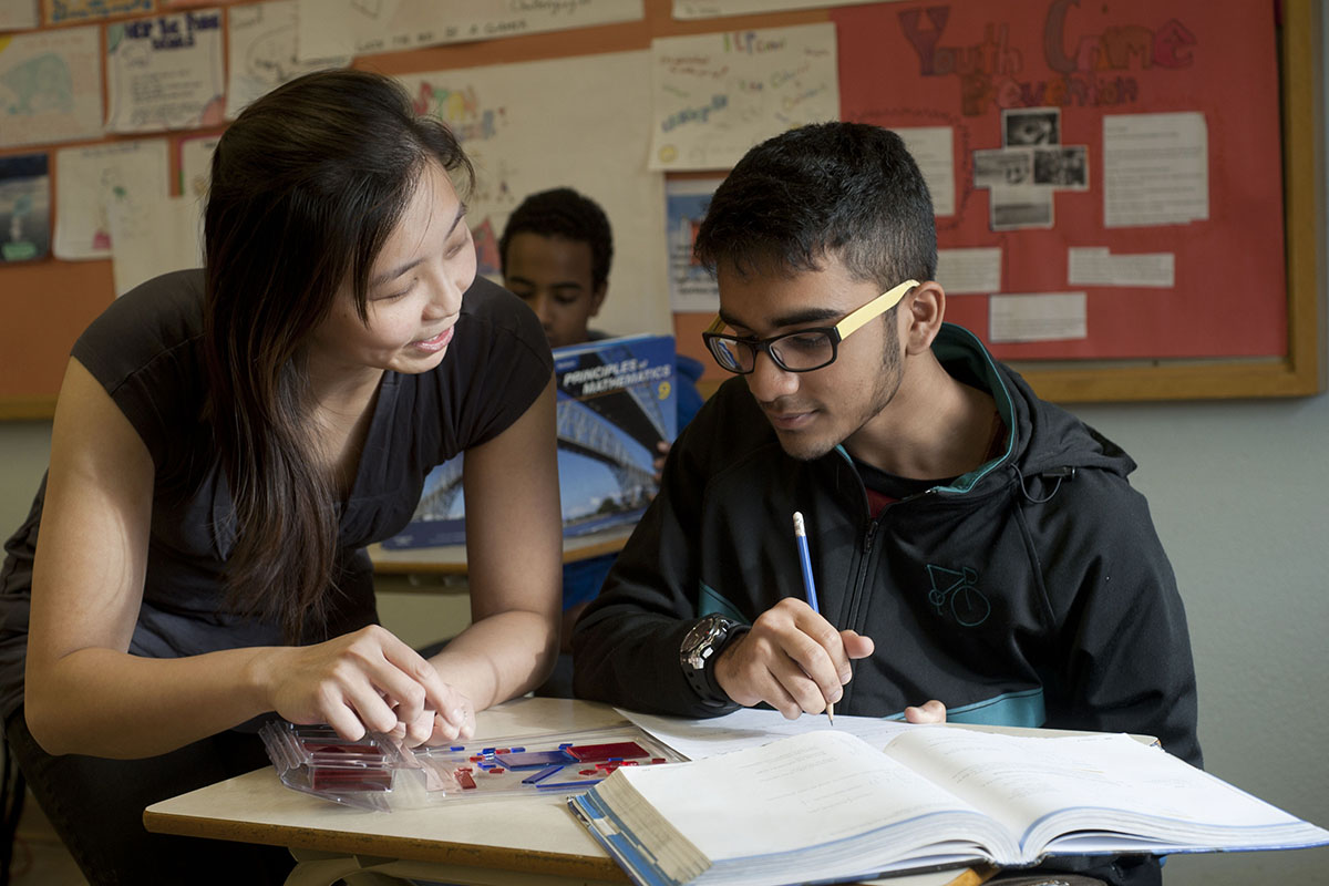 Educator supporting student with math work
