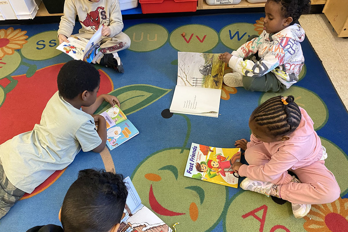 Young students reading on the floor