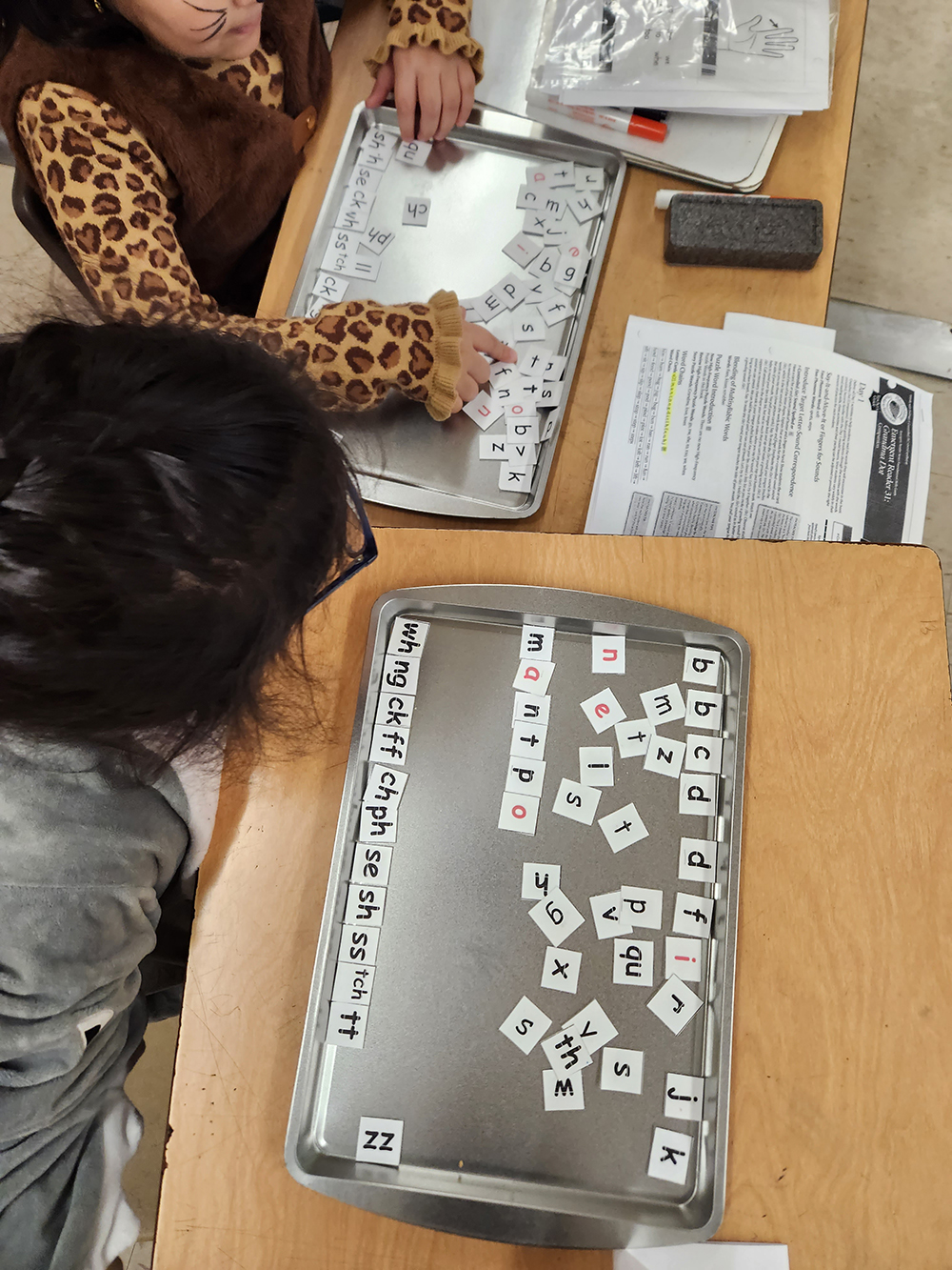 Two students using word tiles to practise words