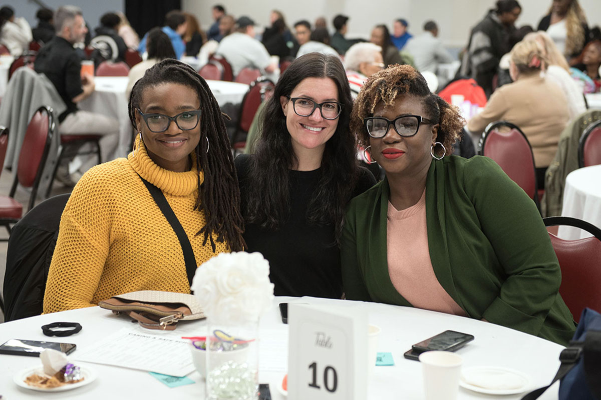 Three educators seated at table together