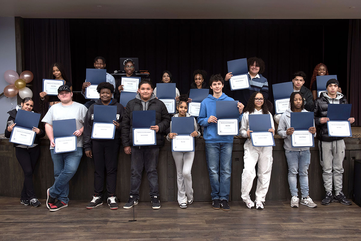 Group of students standing and holding certificates