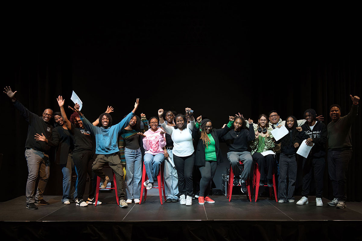 Group of students and educators on a stage
