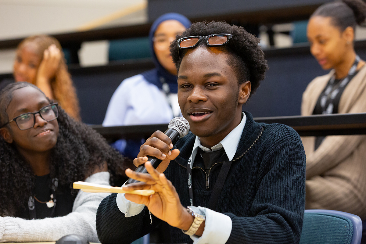 Student holding mic and speaking