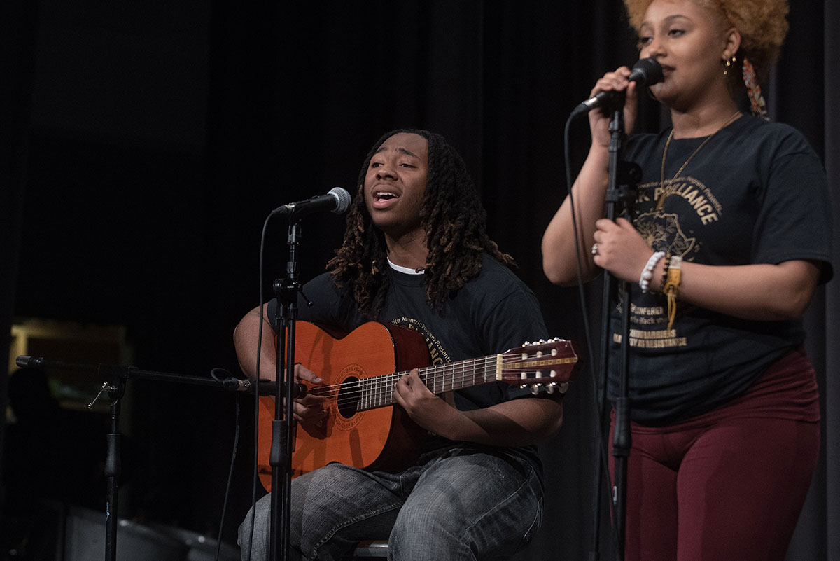 Students singing and playing guitar