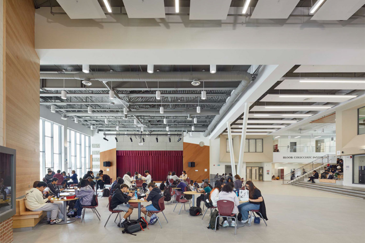 Open space learning space with tables and chairs with students collaborating