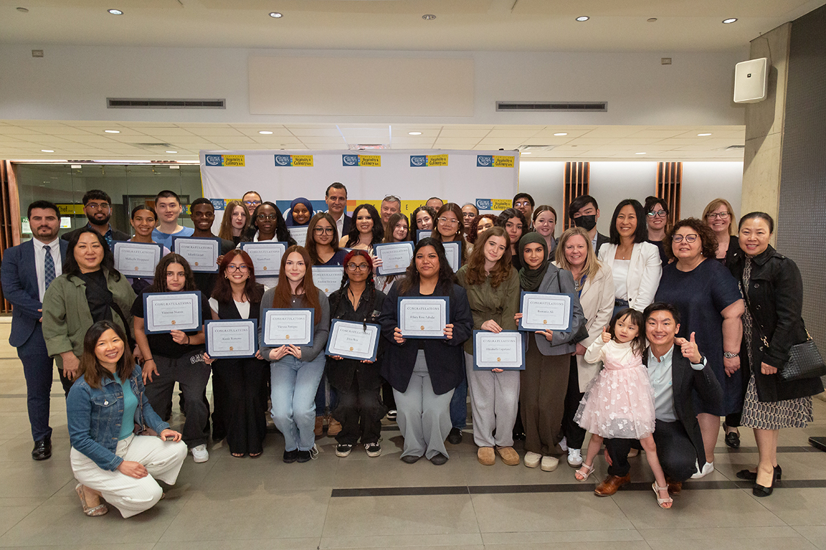 Group of students standing and holding certificates