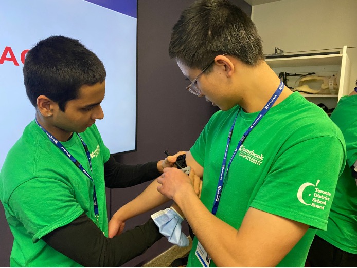 Two students practising medical skills
