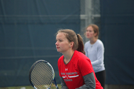 A girl is playing tennis